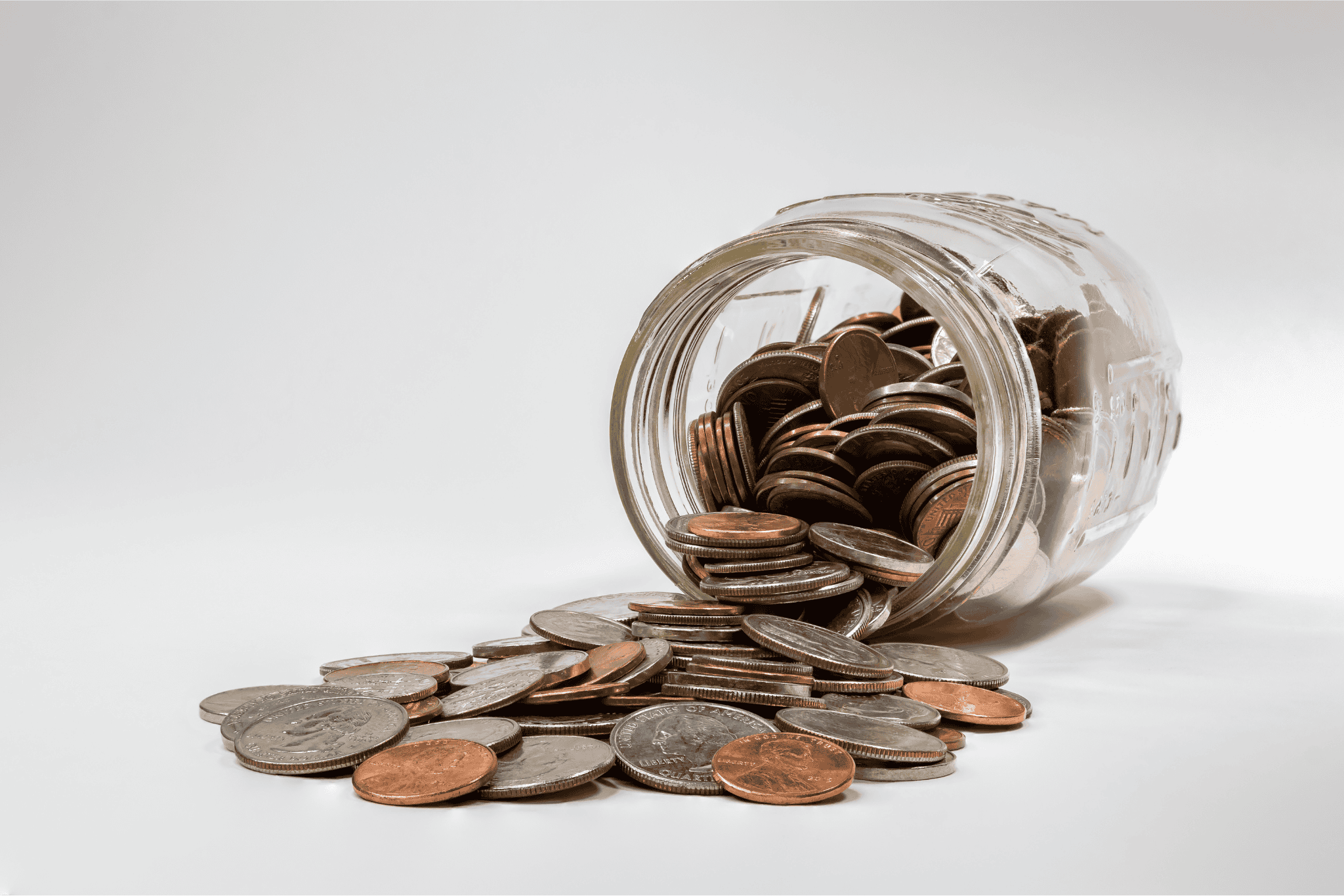 Person Putting Coin in a Piggy Bank