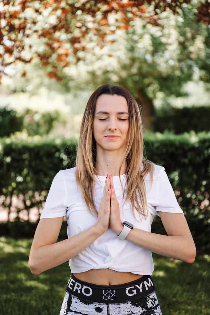 Woman in White Shirt Doing Yoga and Meditation