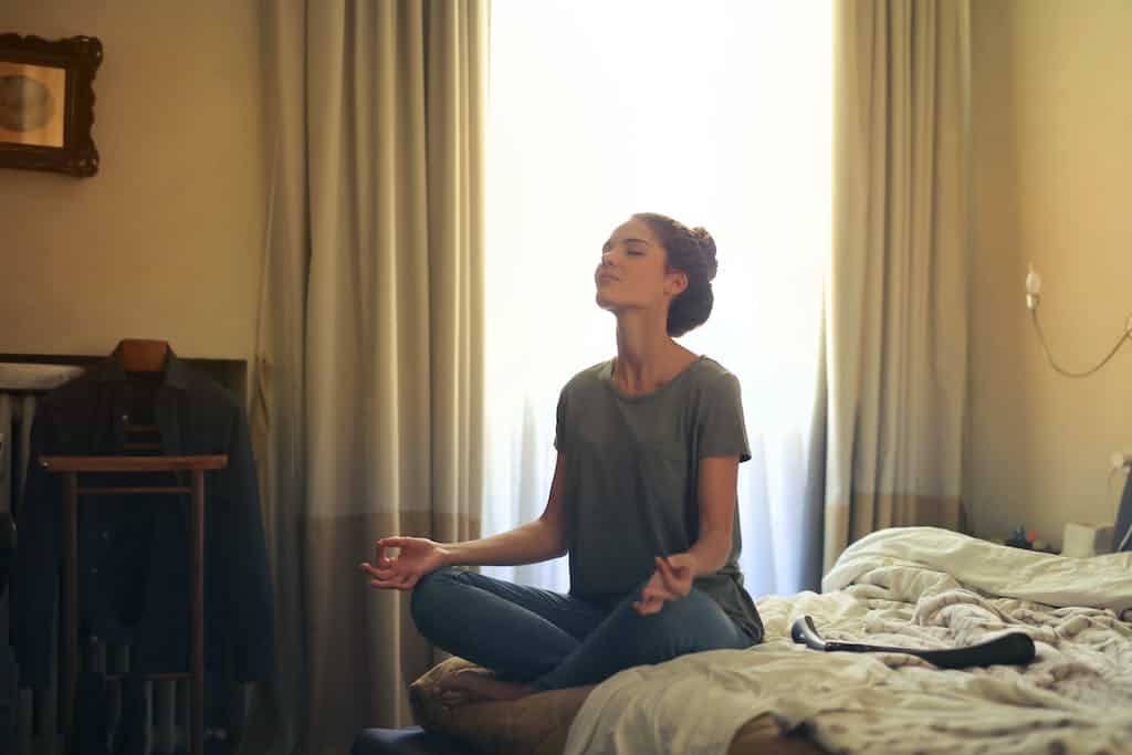 Woman in Meditation on a bed