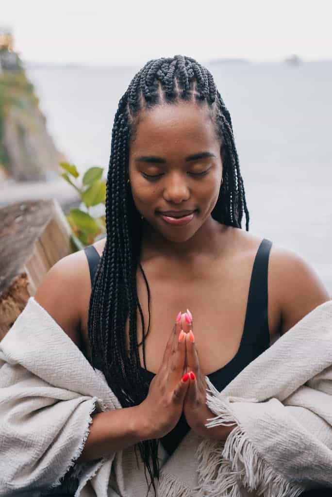 Woman with Braided Hair Meditating Outdoors