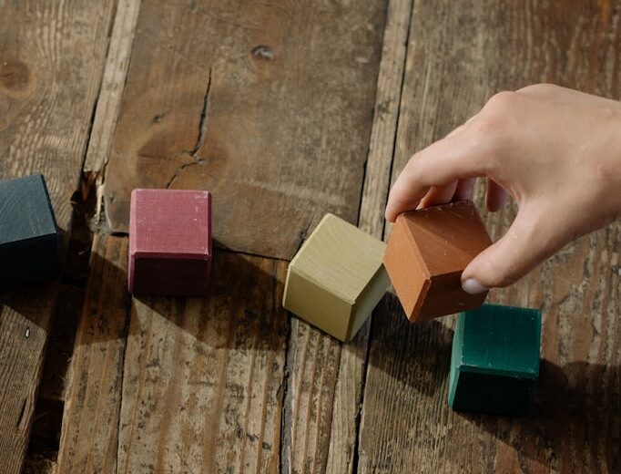 A Kid Holding Wooden Blocks