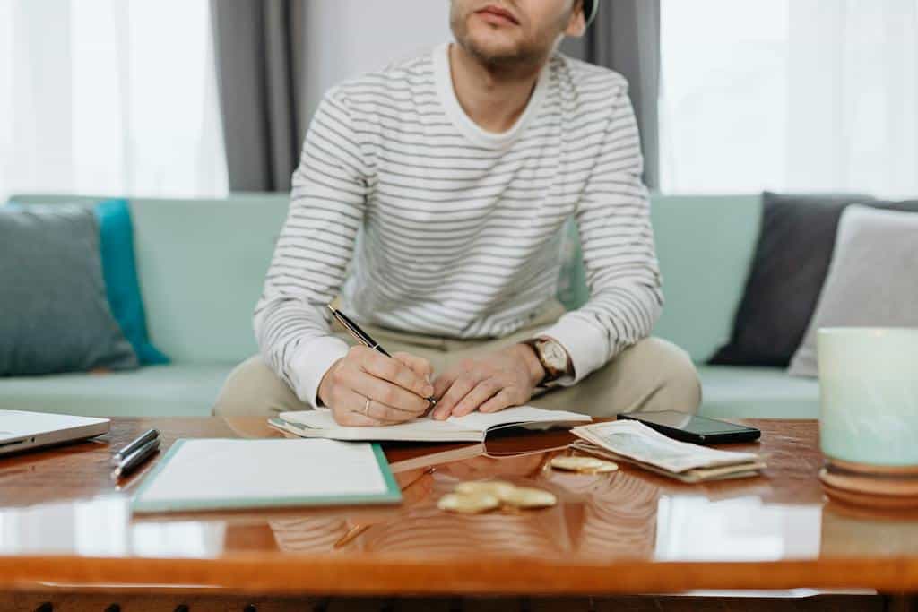 Man in White and Gray Striped Long Sleeve Shirt Sitting at the Table